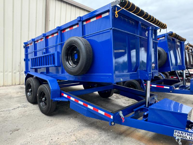 The image shows a large blue dump truck parked on an asphalt surface with a trailer attached to its back.