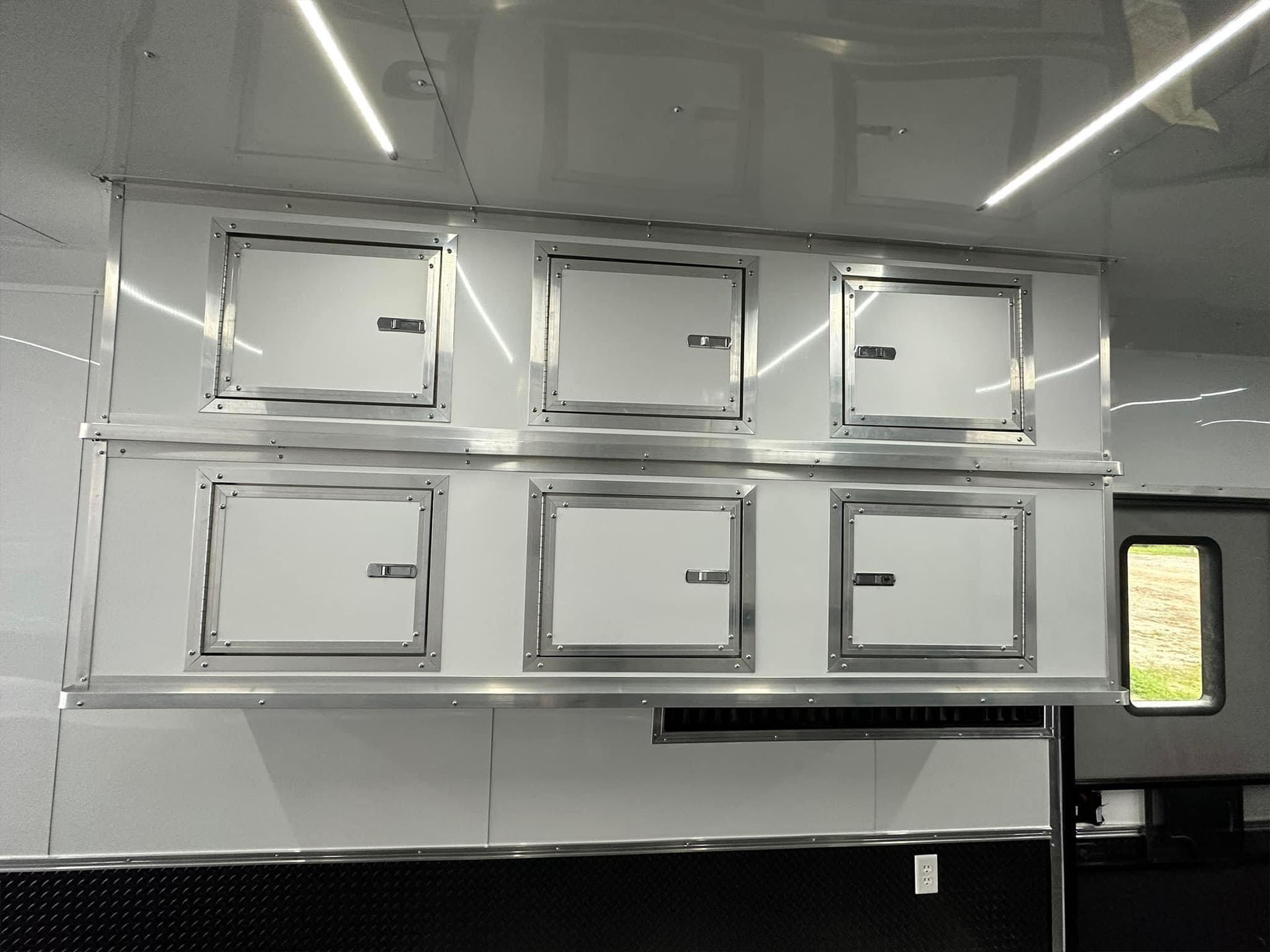 The image shows a stainless steel appliance with multiple compartments, likely inside a commercial kitchen setting, with a reflective surface and a sleek design.