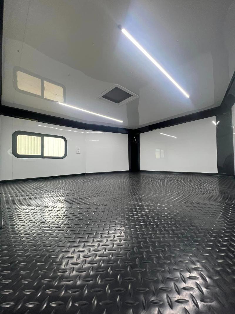 The image displays an interior view of a vehicle with a clean and polished floor, showcasing the spaciousness and sleek design of its cargo area.