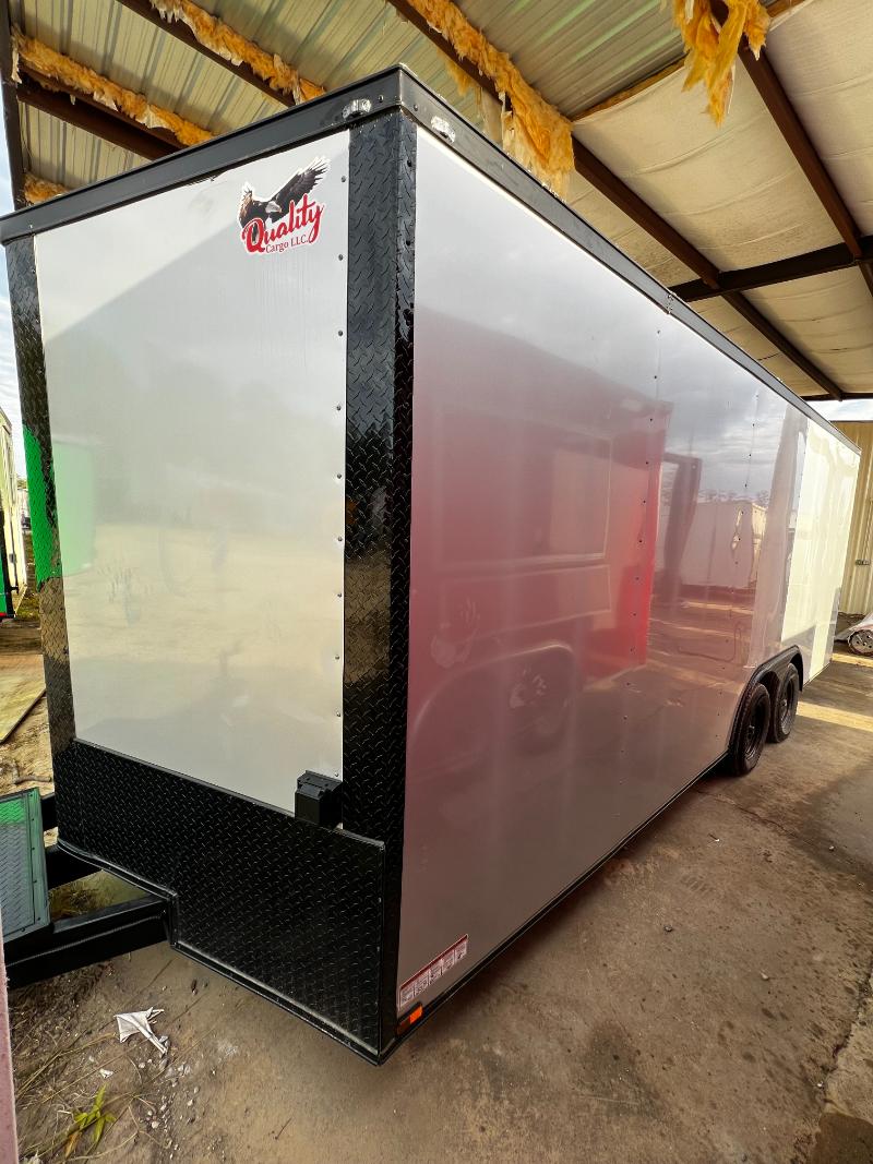 An enclosed trailer parked on a concrete surface.