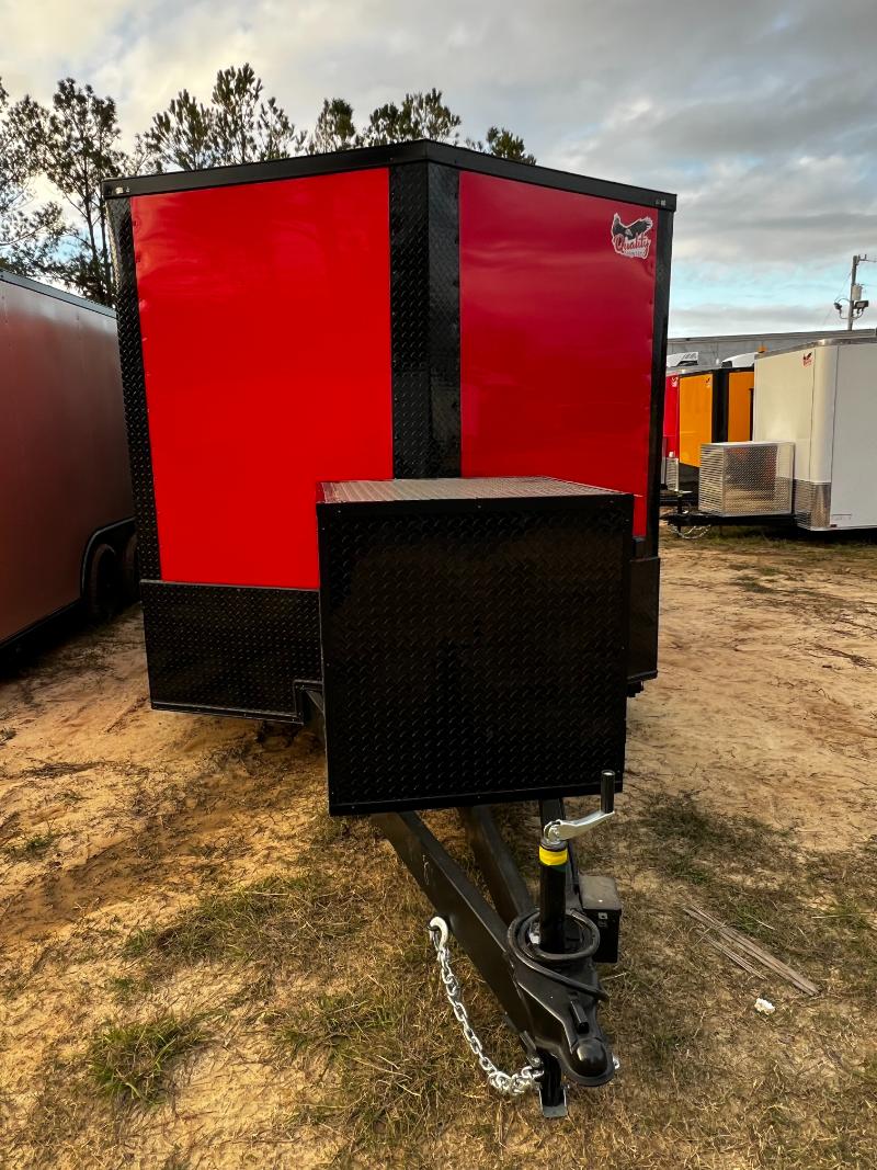 A red and black portable storage unit on a trailer with a chain lock securing the door.